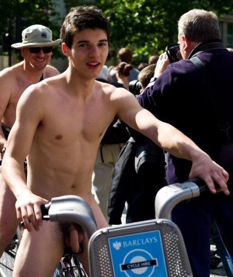 Cute nude boy on a bike