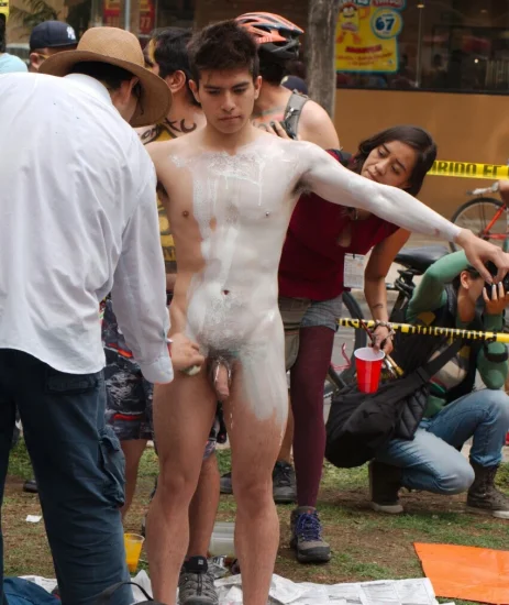 Naked boy getting body painted